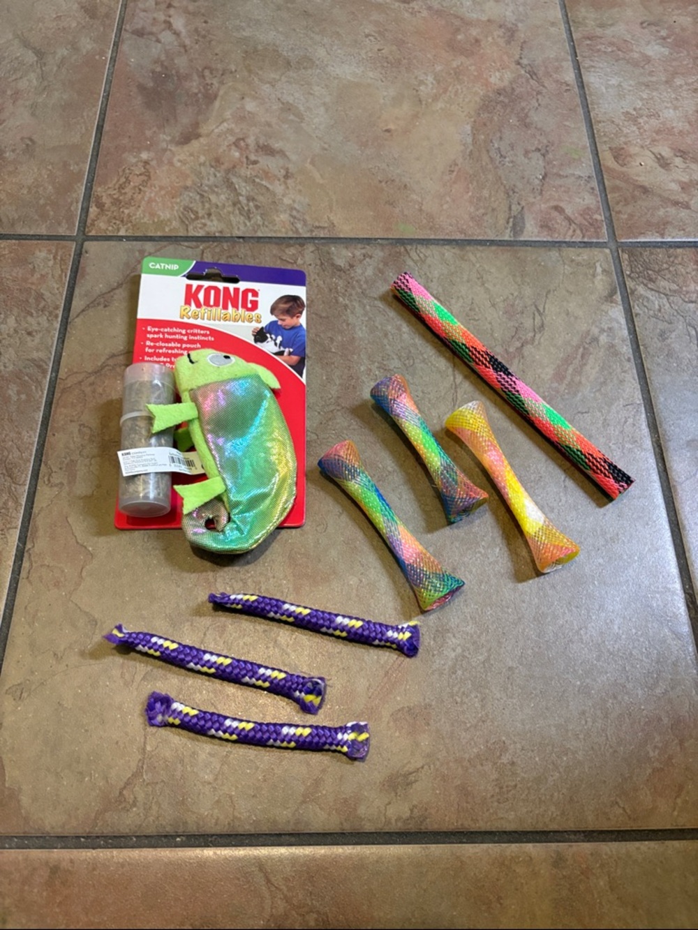 One catnip KONG refillables; Along with various cat toys. See pictures.